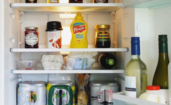 Shared kitchen with fridge full of beer and condiments in our central brighton coworking space